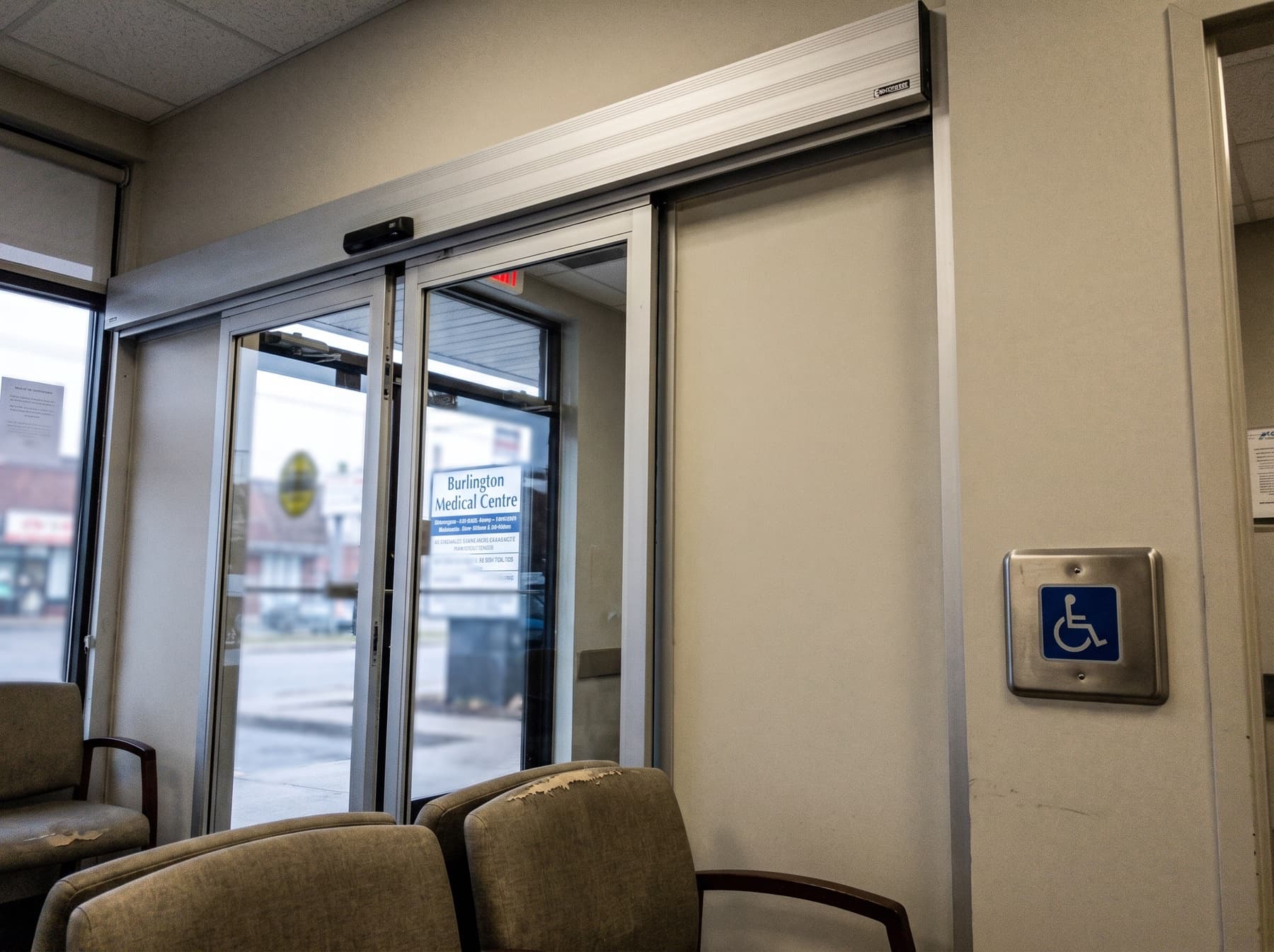 Interior Burlington clinic automatic sliding glass doors on overhead track with push pad mounted inside