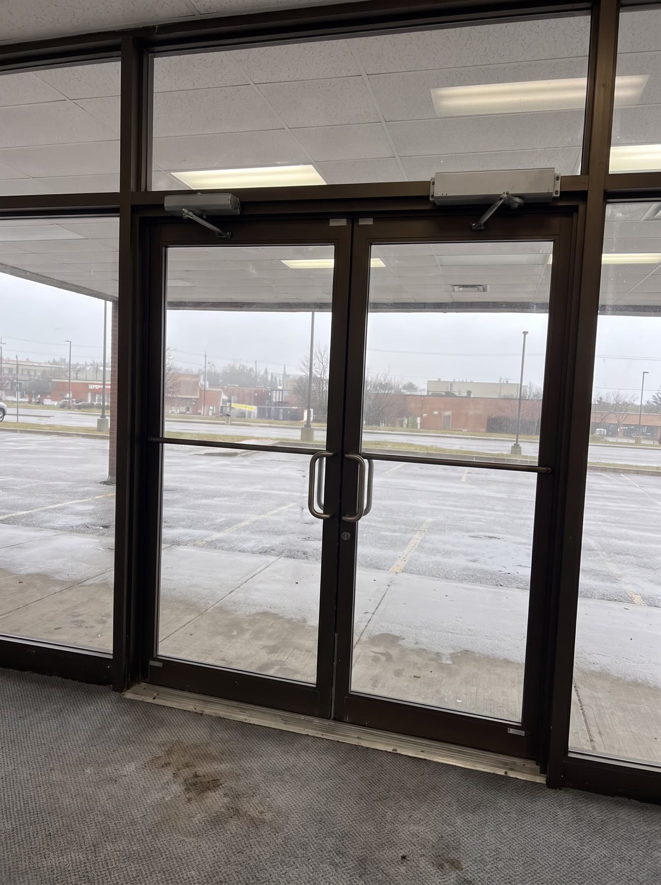 Interior view of a Vaughan commercial aluminum entrance door with hydraulic closer mounted on the inside frame