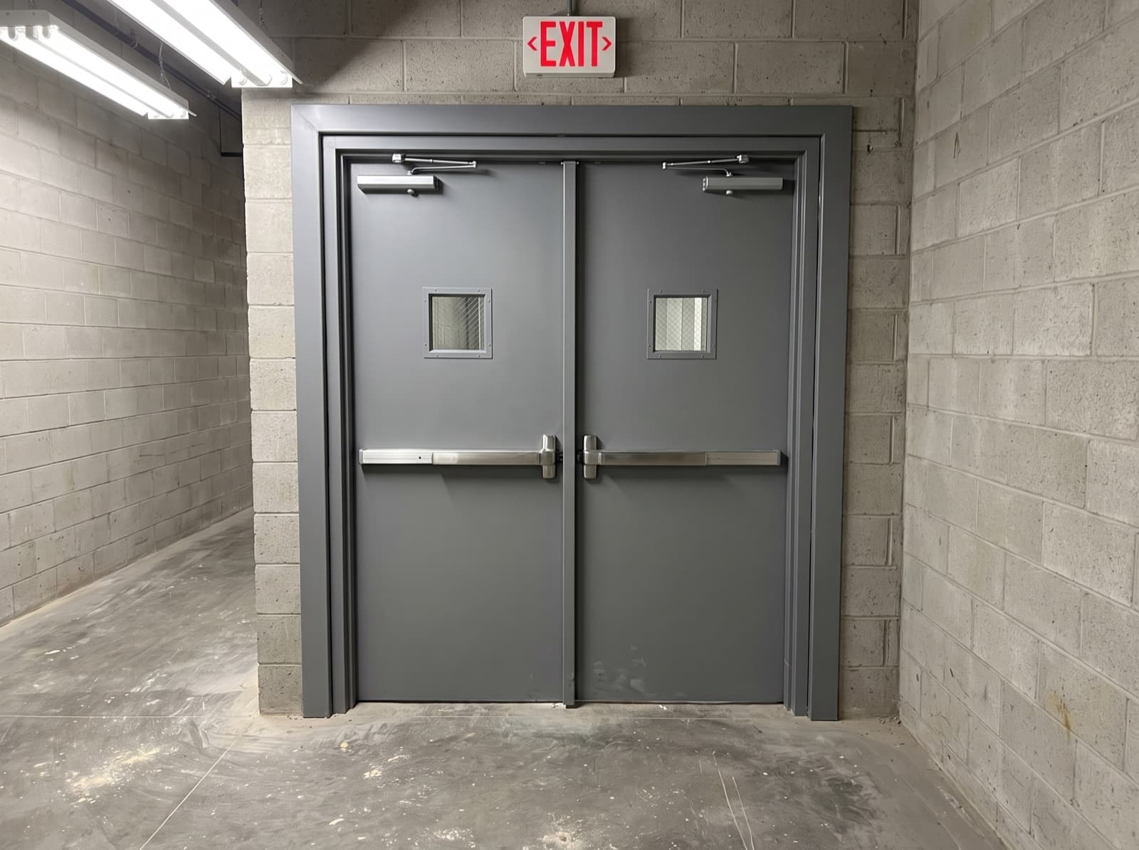 Brampton warehouse hollow metal fire-rated steel doors with panic bars and EXIT sign
