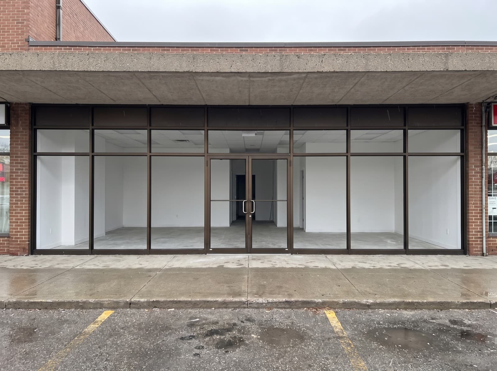 Scarborough retail plaza aluminum storefront with dark bronze frames and double glass entrance doors